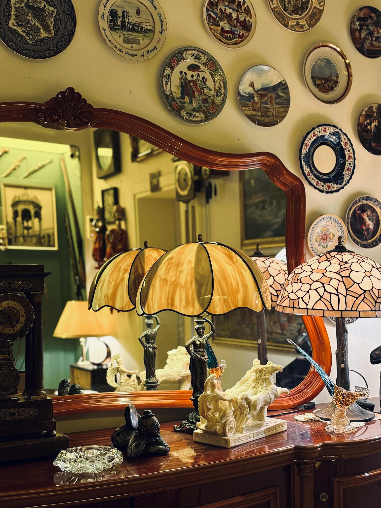 Elegant vintage interior showcasing antiques, decorative lamps and wall plates.